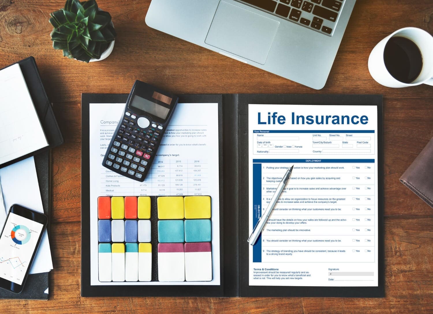 Life insurance documents with calculator for financial planning in Fayetteville, AR
