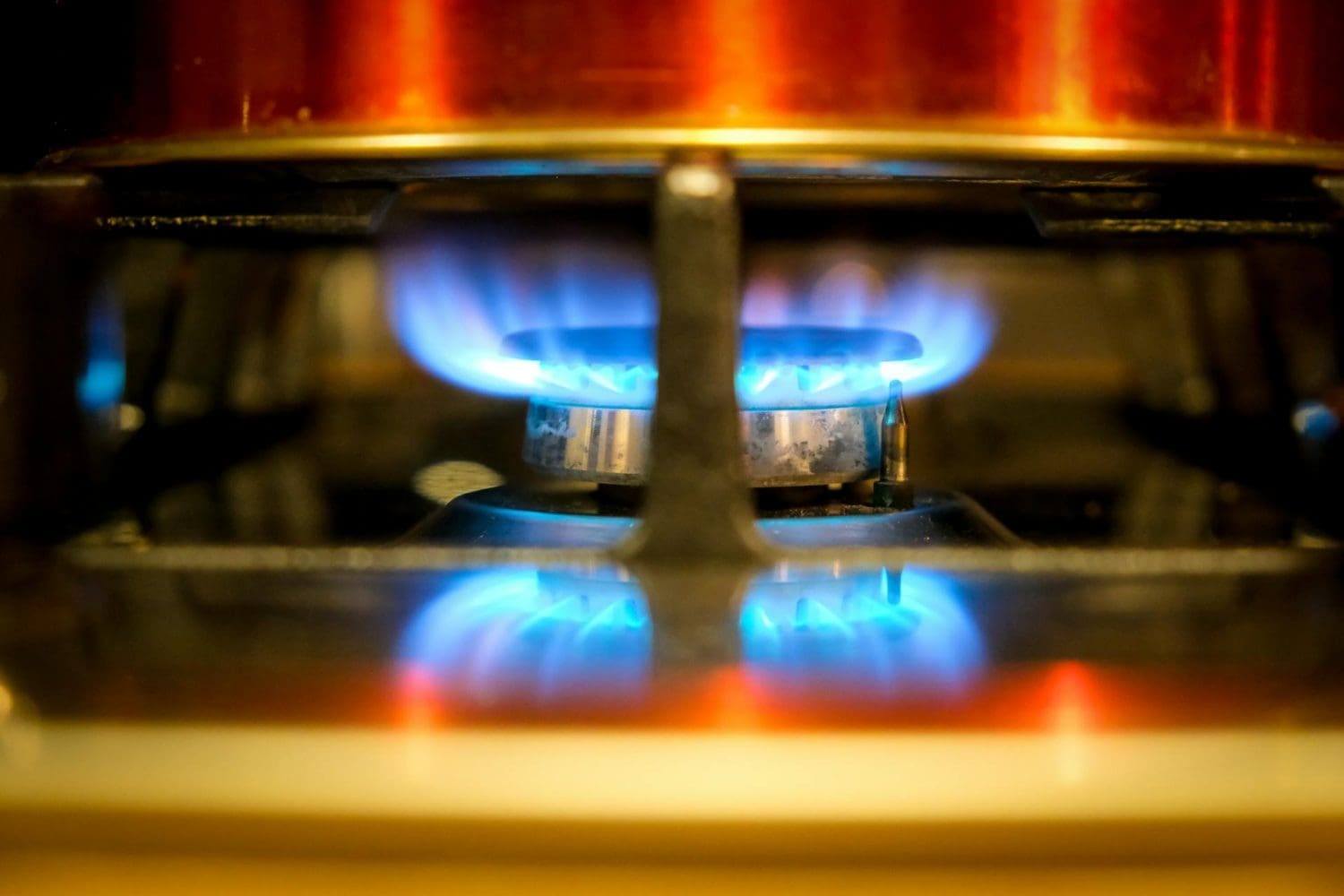 Gas stove burner with an open flame representing gas leak risks and homeowners insurance coverage.